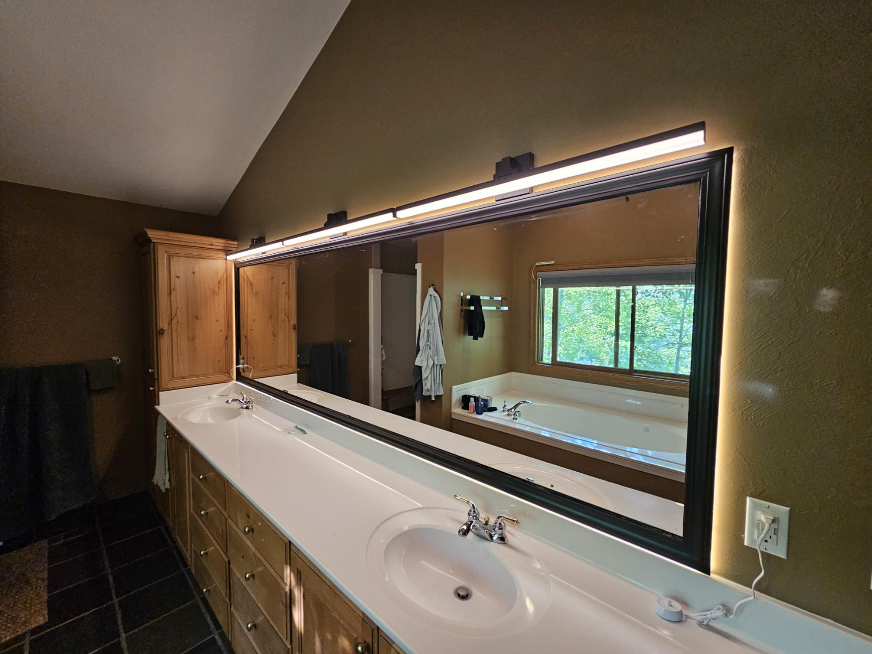 Large bathroom vanity with long lighted mirror