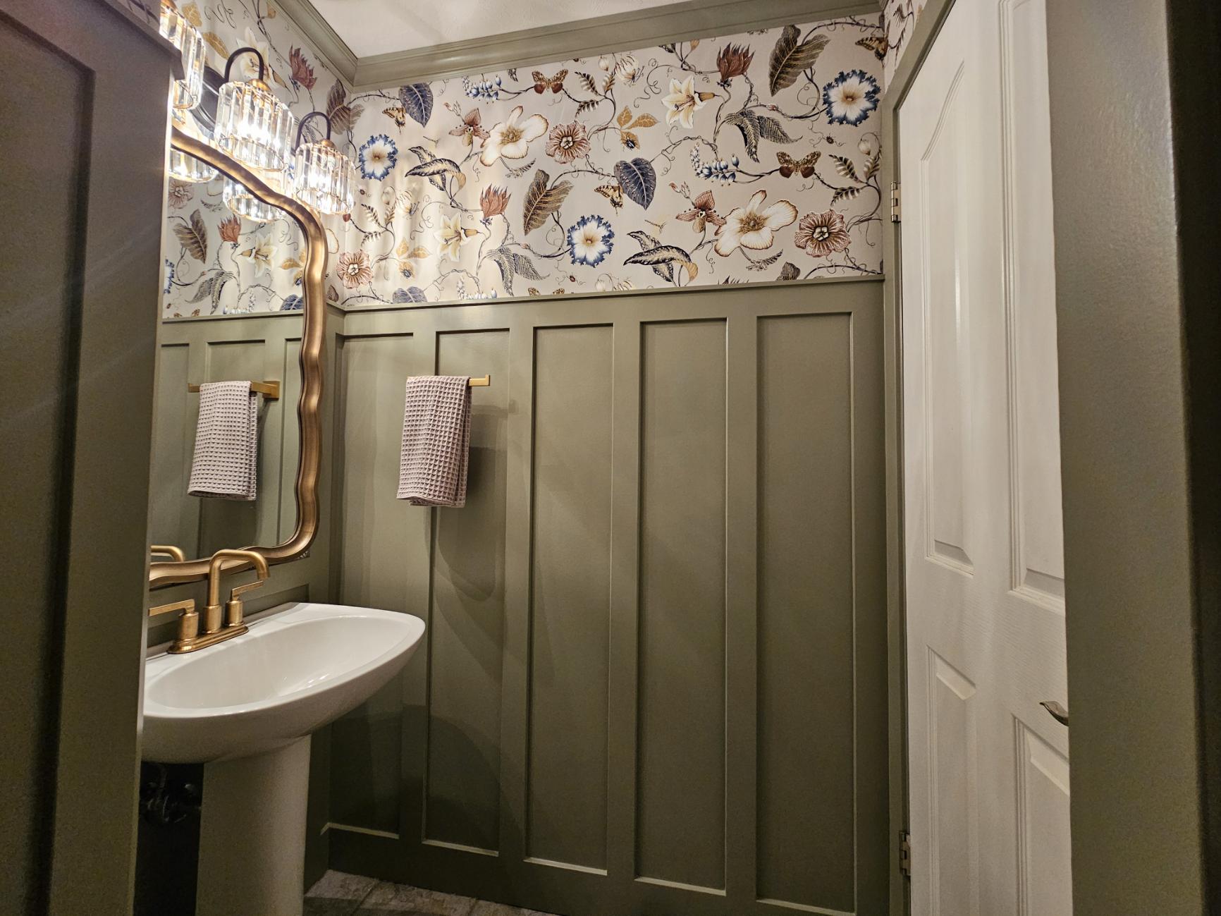 Finished powder room with wallpaper and sage wainscoting