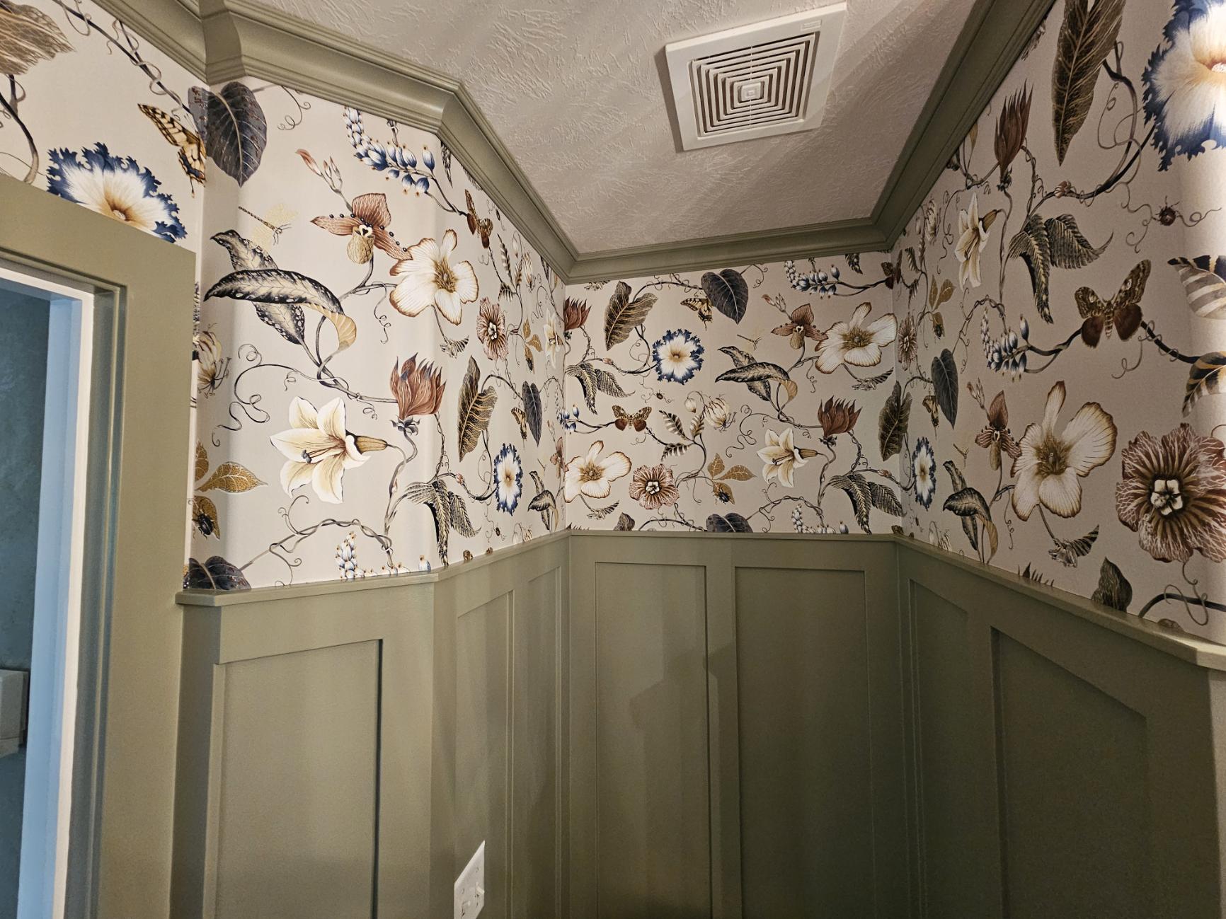 Close detail of floral wallpaper and green wainscoting